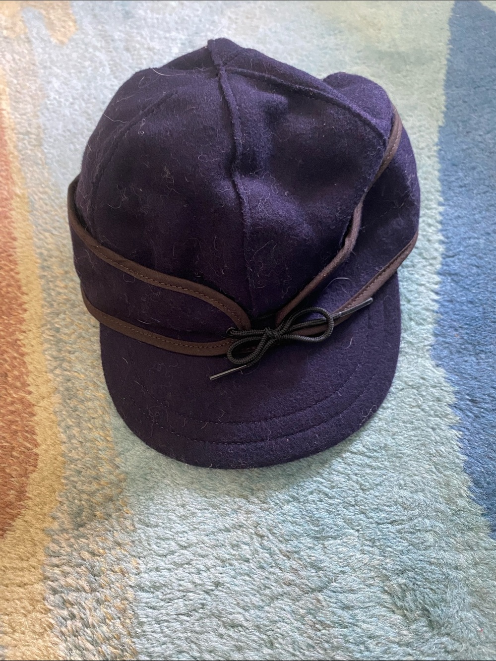 Stormy Kromer Navy Wool Cap with Brown Trim and Decorative Bow